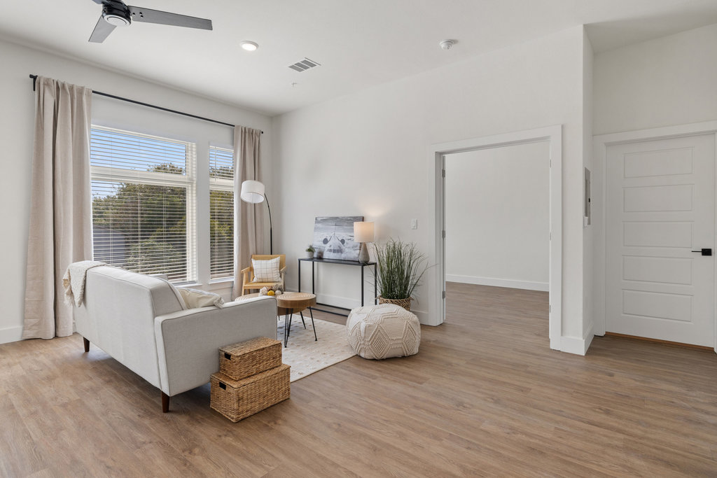 1811 Webberville Road, Unit 1209 Austin, TX 78721 - Photo 6 of 35 a living room with furniture and wooden floor