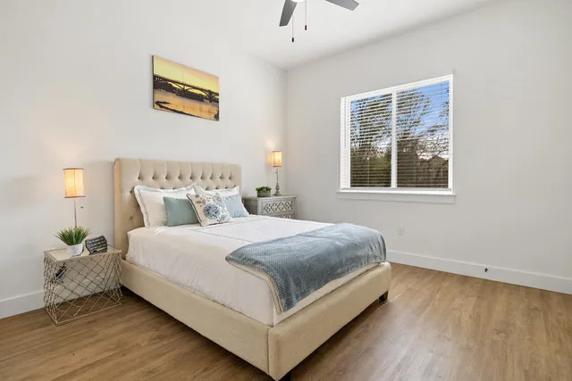 a bedroom with a bed lamp and window