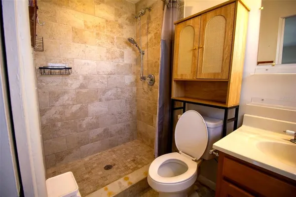 a bathroom with a toilet and a shower