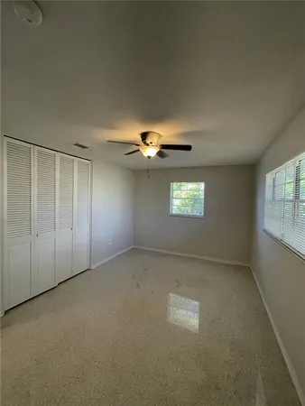 a bathroom with a granite countertop sink and a toilet