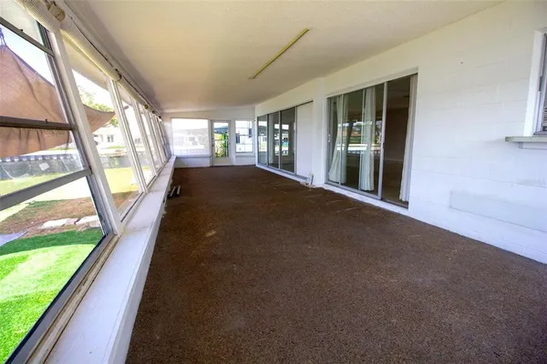 a view of an empty room with a floor to ceiling window