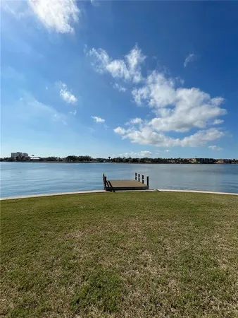 a view of river and deck with seating area