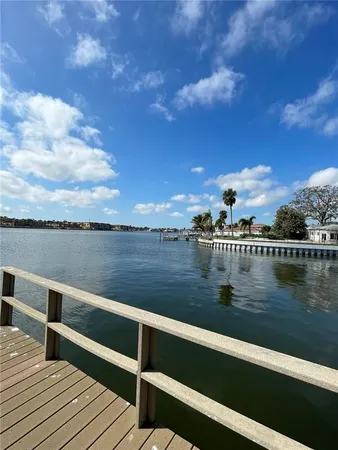 a view of a lake with houses in the back
