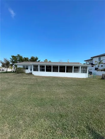 a view of a house with a yard and garage