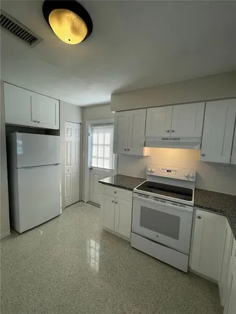 a kitchen with a stove and a microwave