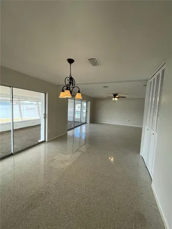 an empty room with windows and pillars in it