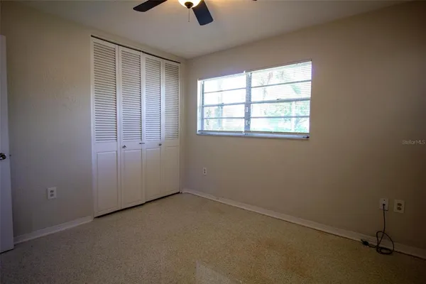 an empty room with a empty space and windows