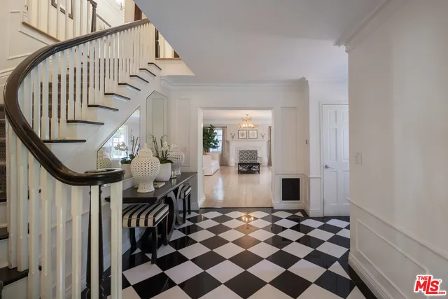 a view of a hallway with a black and white checkered floor
