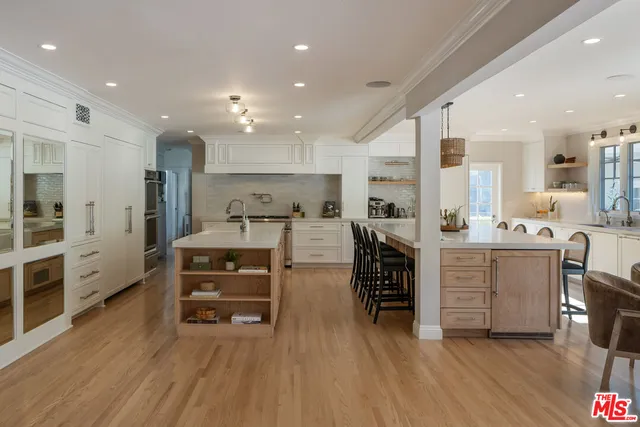 a view of a dining room kitchen with furniture and chandelier