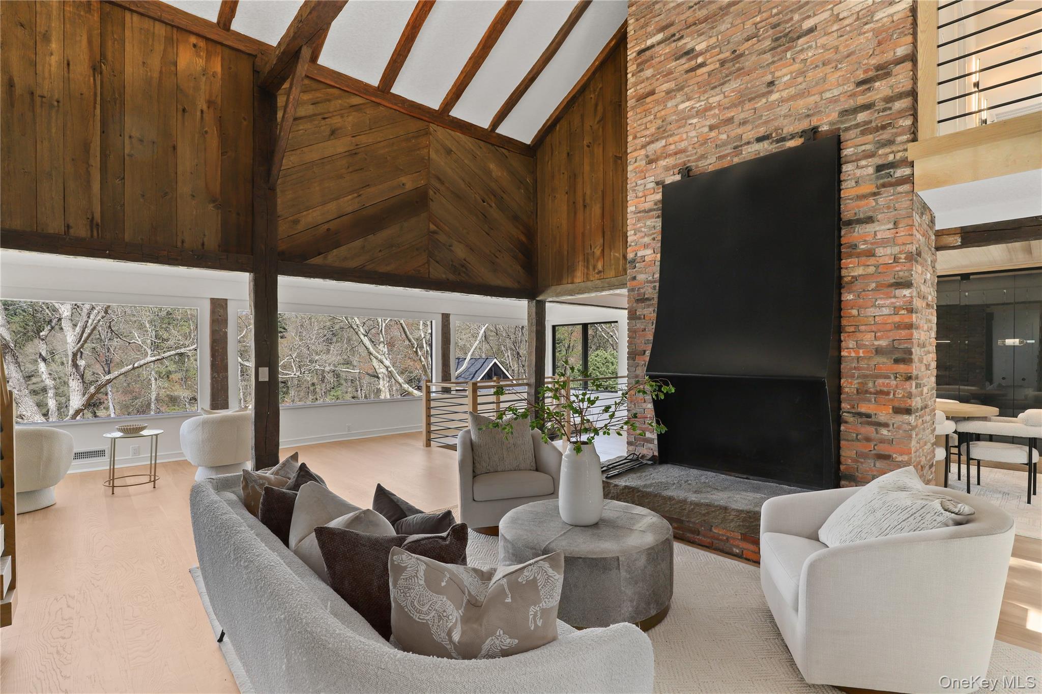 39 Old Snake Hill Road Pound Ridge, NY 10576 - Photo 6 of 37 a living room with fireplace furniture and a floor to ceiling window