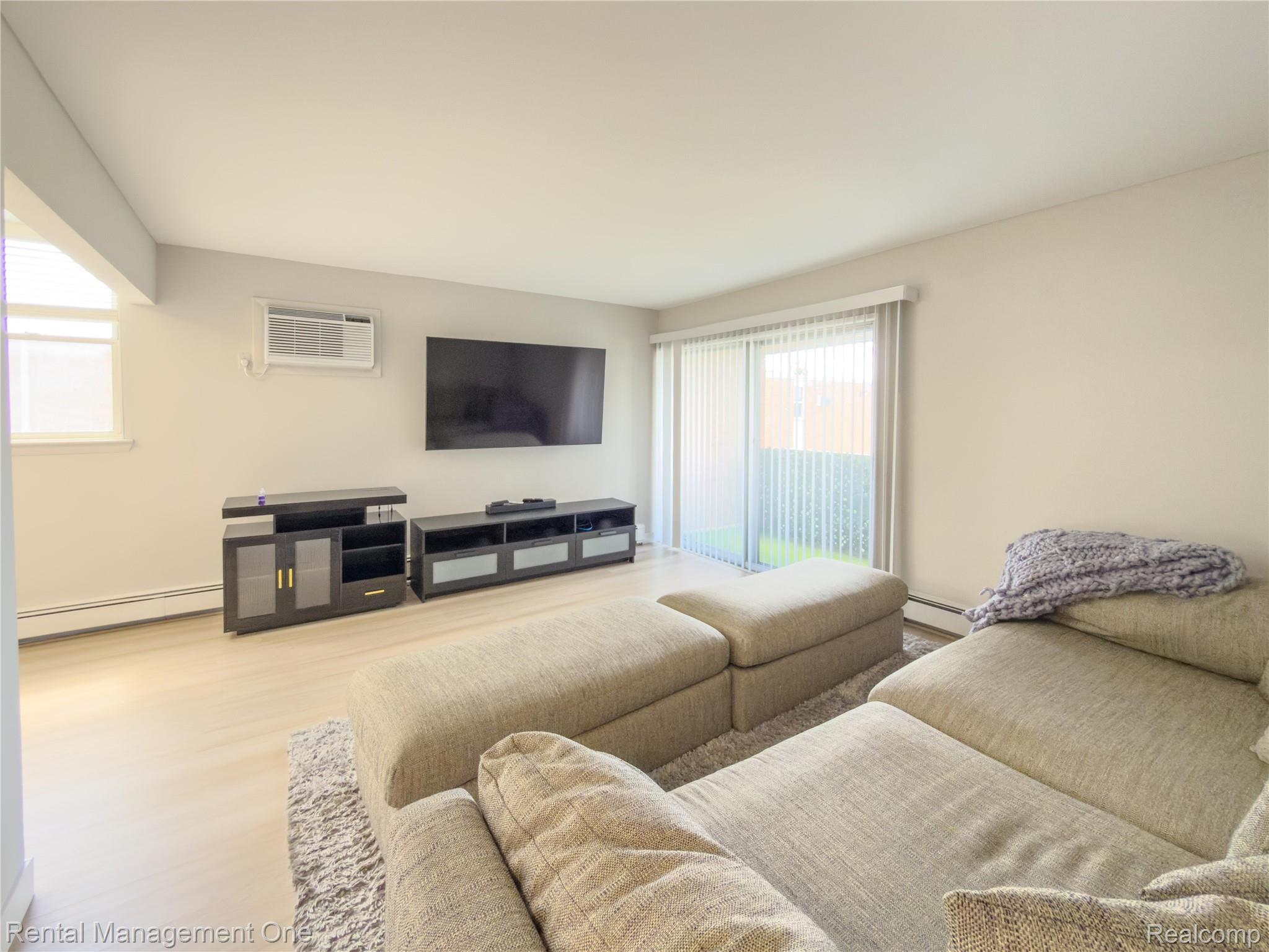 1603 Cass Lake Road, Unit D Keego Harbor, MI 48320 - Photo 13 of 20 Living area with light wood-finish flooring and neutral wall tones