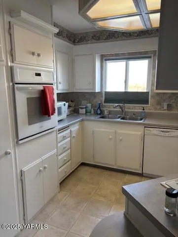 a kitchen with a sink cabinets and window
