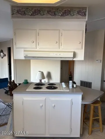 a kitchen with granite countertop a sink and cabinets