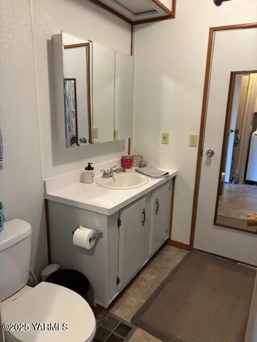 a bathroom with a sink a toilet and mirror