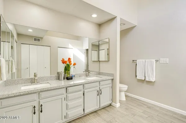 a bathroom with a granite countertop sink mirror and double