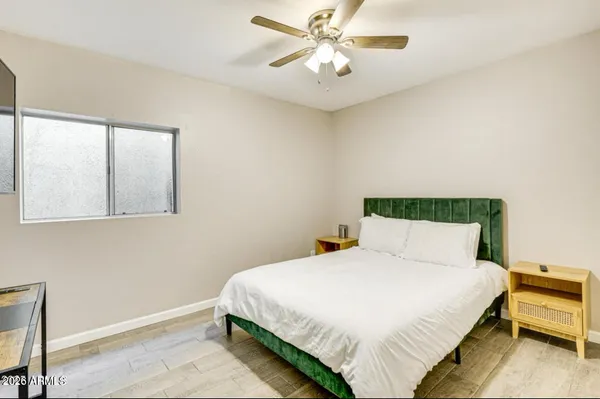 a bedroom with a bed and a chandelier