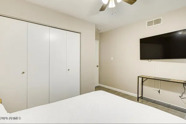 a bedroom with a bed and a flat screen tv