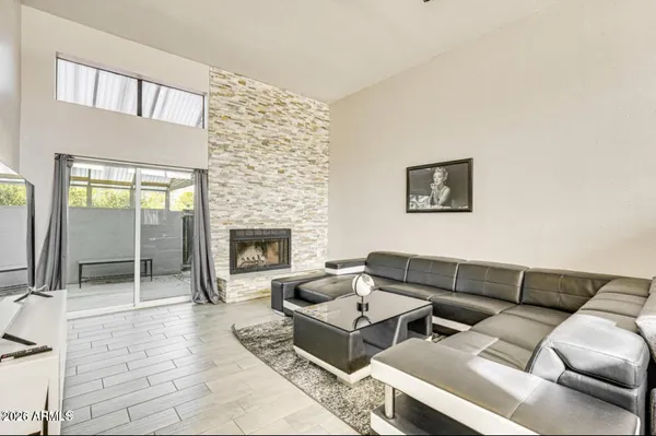 a living room with furniture and a fireplace