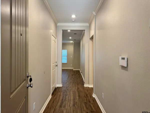 a view of a hallway with wooden floor