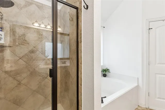 a bathroom with a bathtub and shower