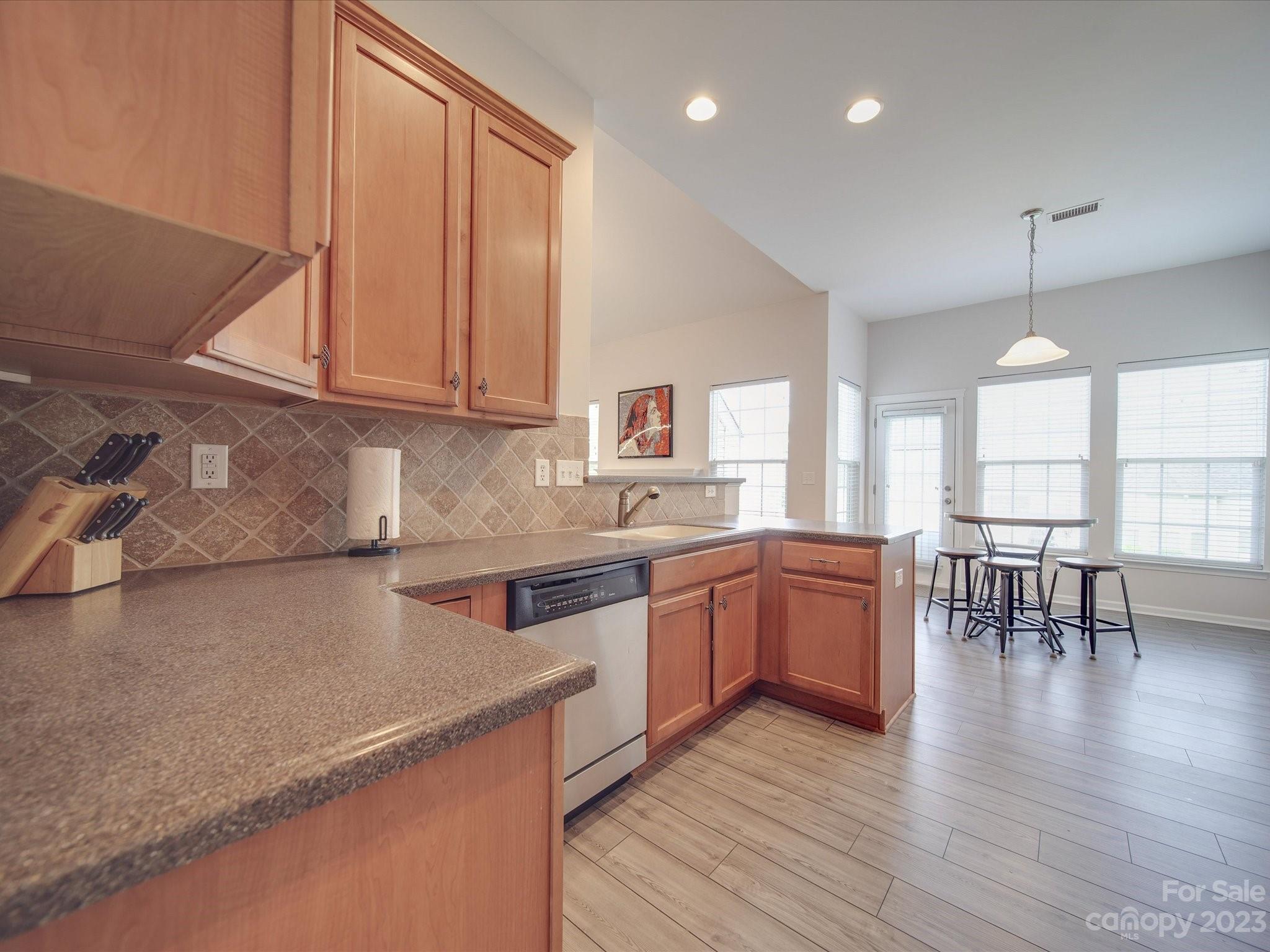 10102 Trailmoor Road Charlotte, NC 28278 - Photo 13 of 44 a kitchen with a wooden floor and window