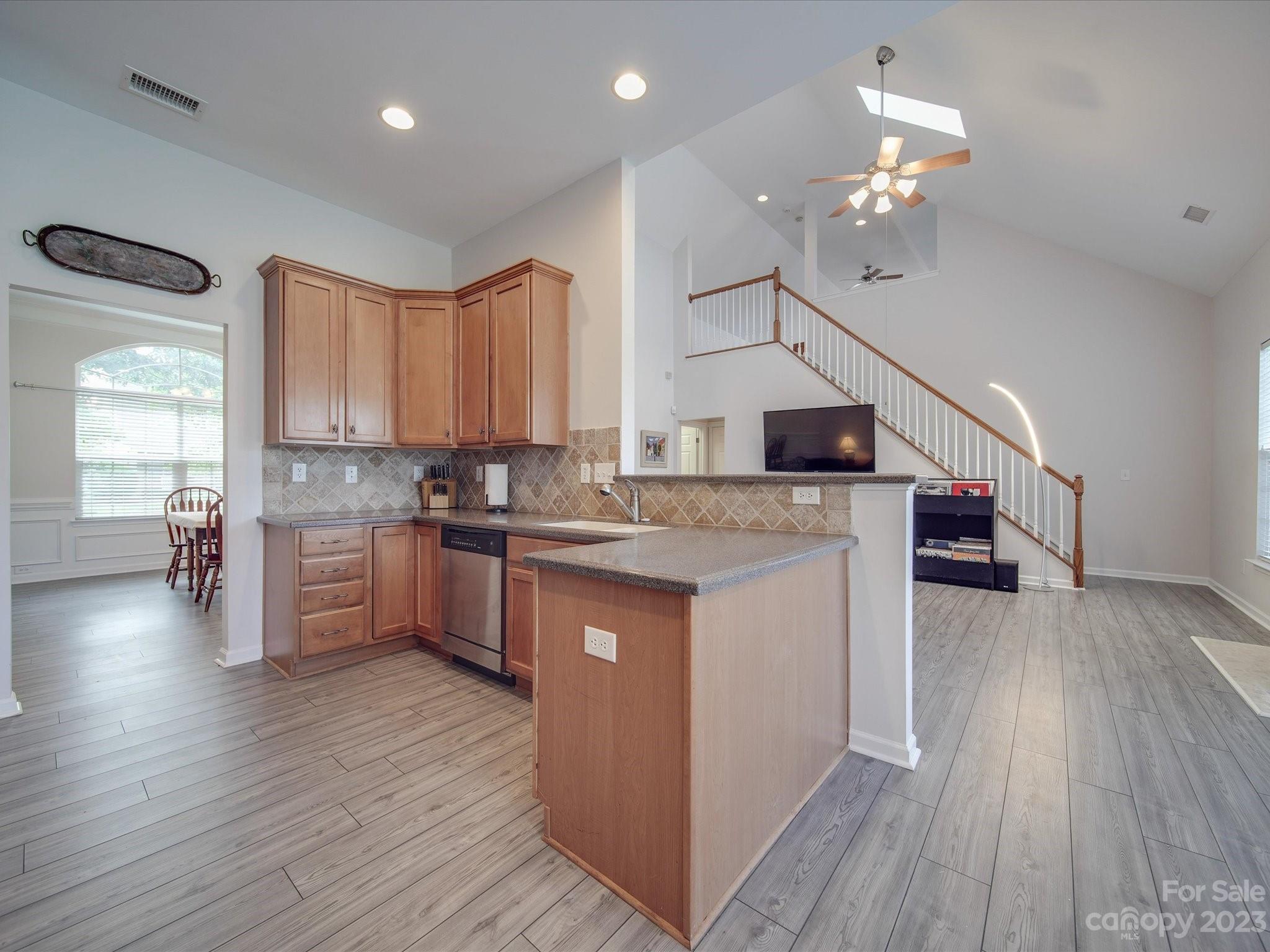 10102 Trailmoor Road Charlotte, NC 28278 - Photo 16 of 44 a kitchen with stainless steel appliances granite countertop wooden floors a stove and a refrigerator