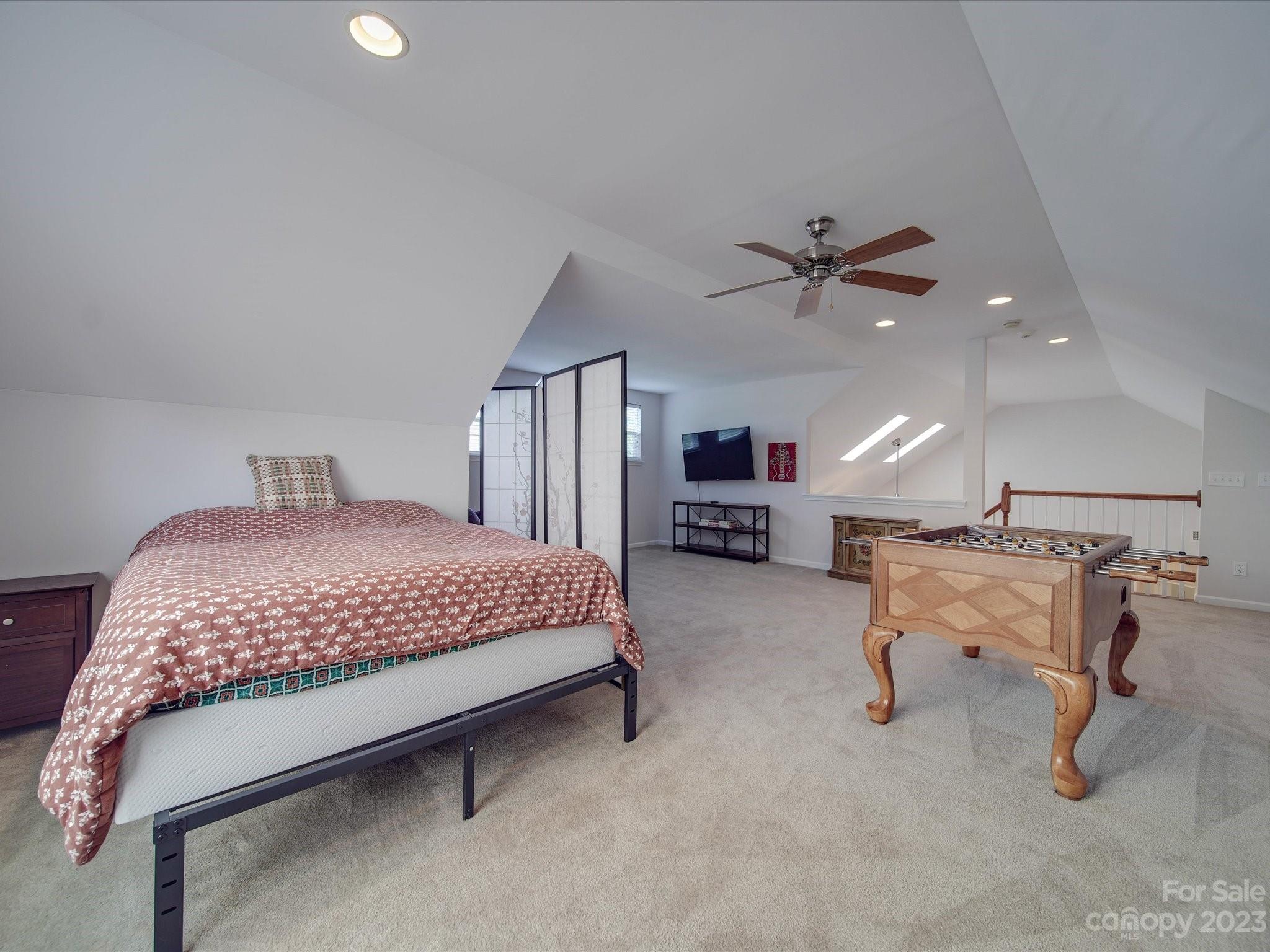 10102 Trailmoor Road Charlotte, NC 28278 - Photo 23 of 44 a bedroom with a bed and a chandelier