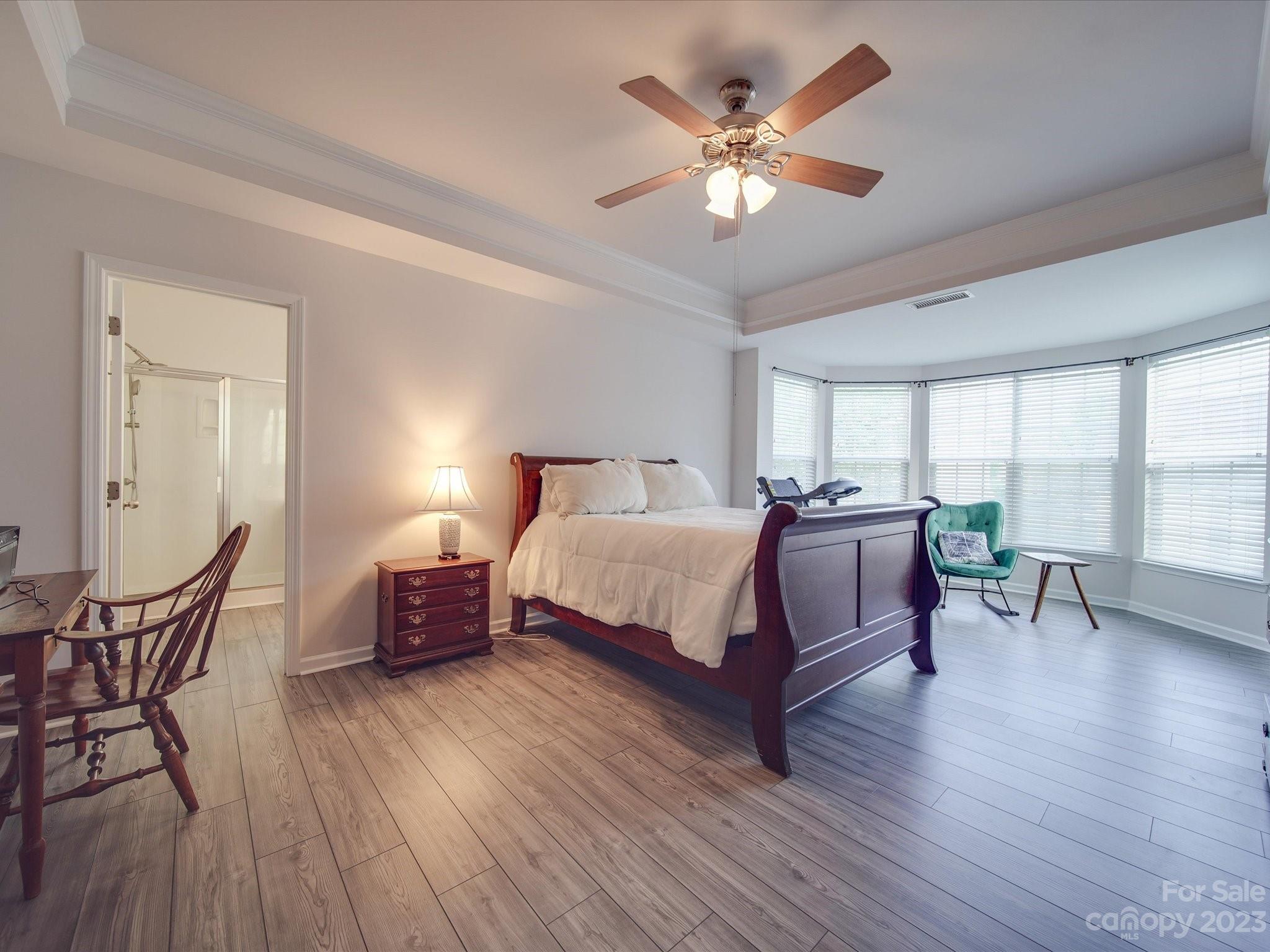 10102 Trailmoor Road Charlotte, NC 28278 - Photo 26 of 44 a spacious bedroom with a bed a chandelier and a window