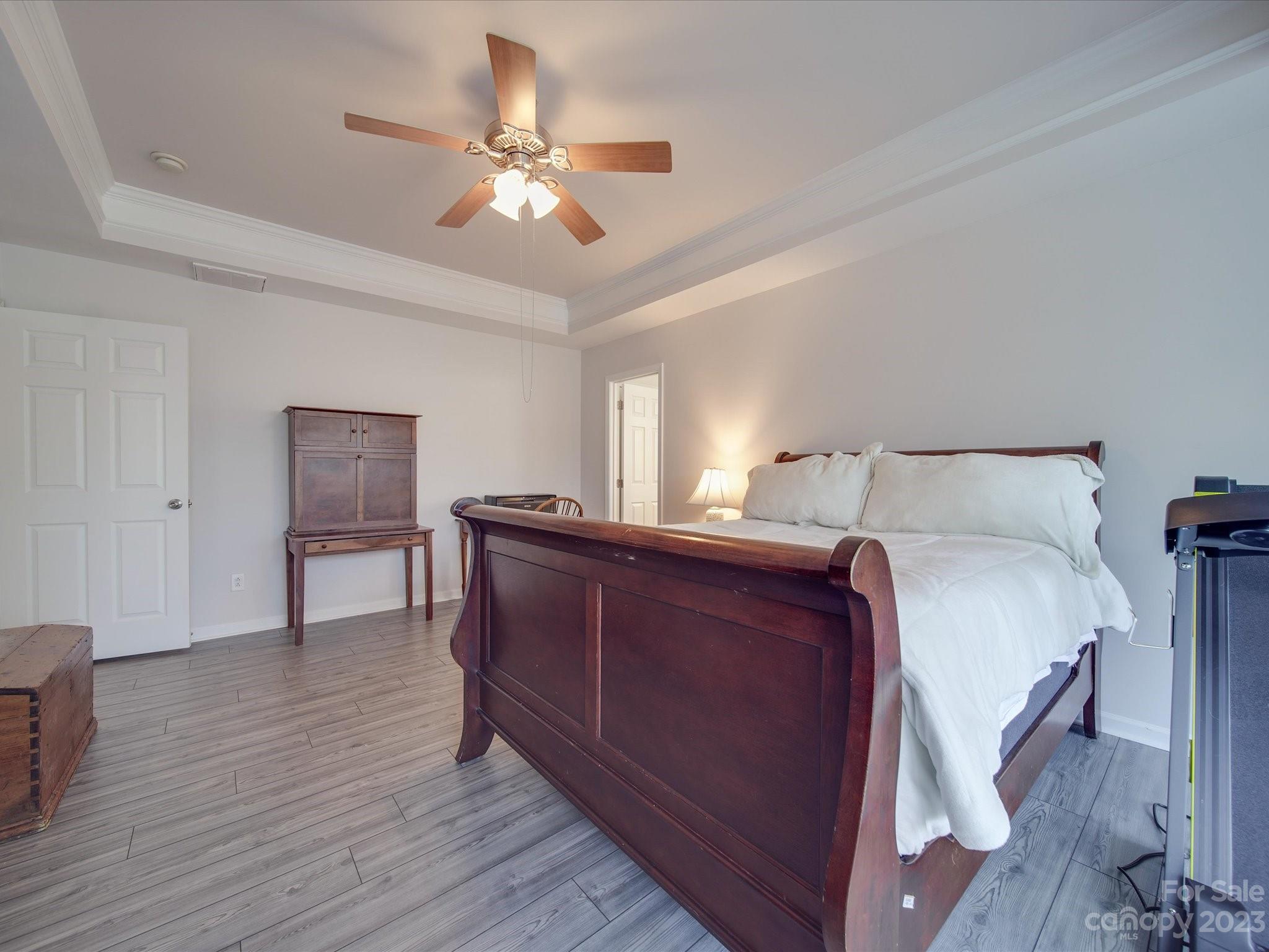 10102 Trailmoor Road Charlotte, NC 28278 - Photo 30 of 44 a bedroom with a bed and a chandelier