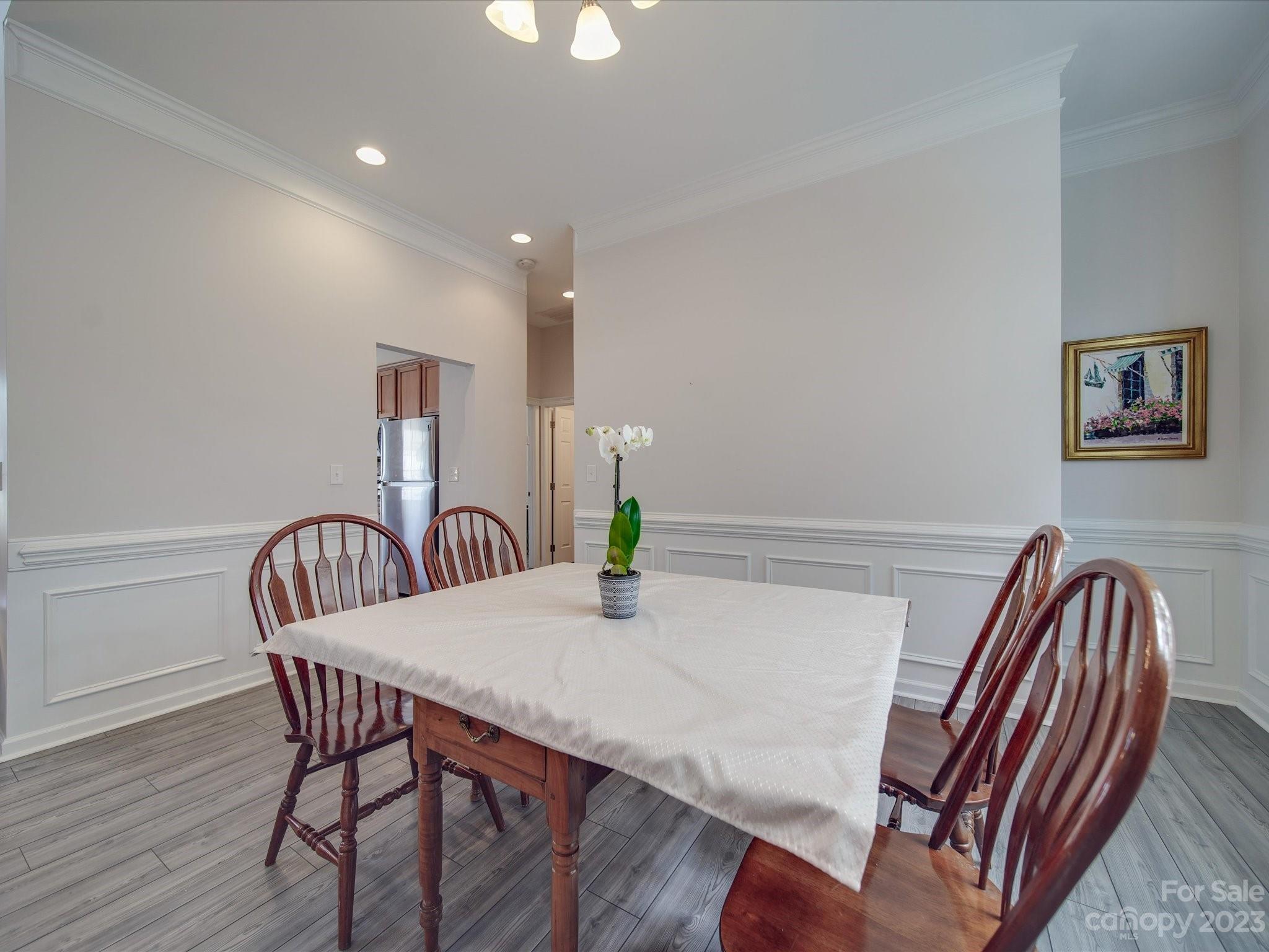 10102 Trailmoor Road Charlotte, NC 28278 - Photo 7 of 44 a dining room with furniture and wooden floor