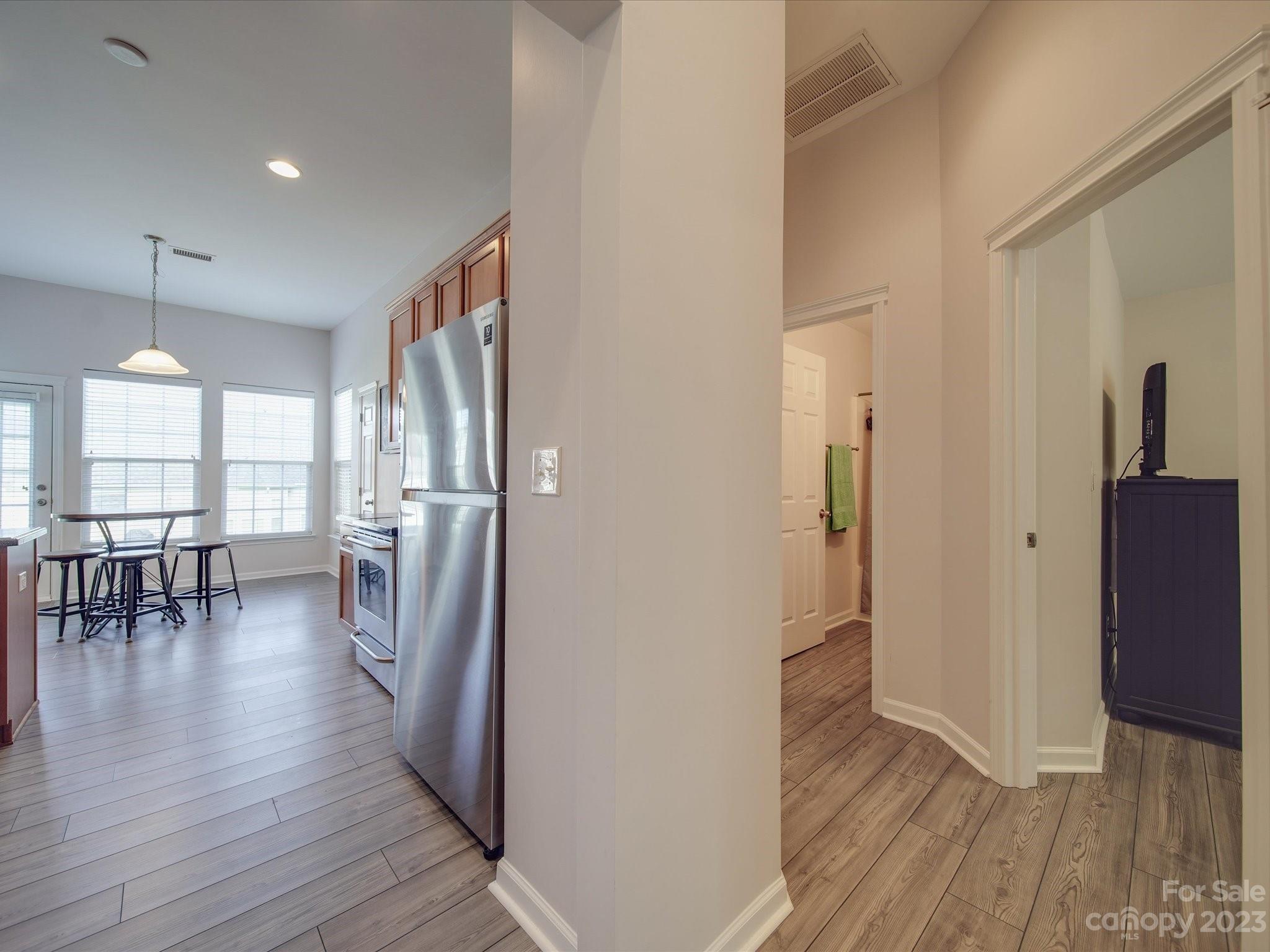 10102 Trailmoor Road Charlotte, NC 28278 - Photo 8 of 44 a view of a hallway with wooden floor windows and a livingroom