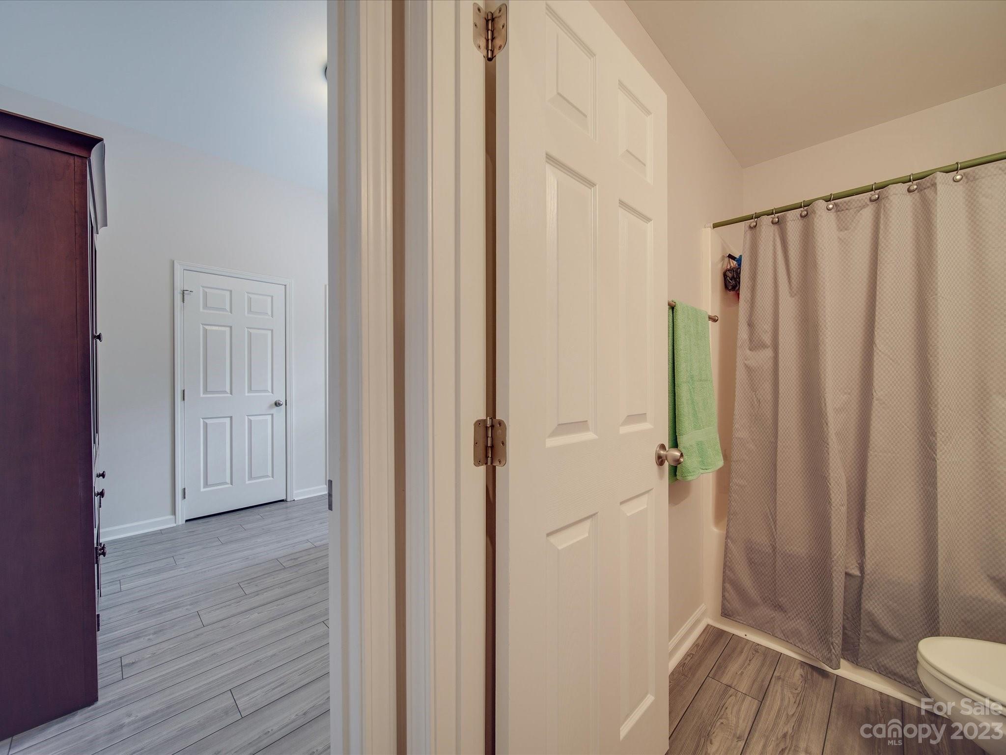 10102 Trailmoor Road Charlotte, NC 28278 - Photo 10 of 44 a view of a bathroom with a sink and wooden floor
