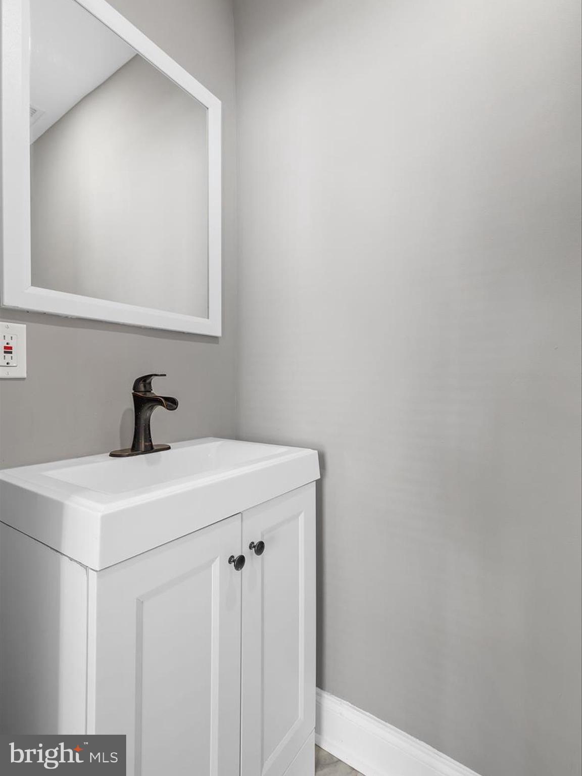 3032 Chelsea Terrace Baltimore, MD 21216 - Photo 13 of 29 a bathroom with a sink and a mirror