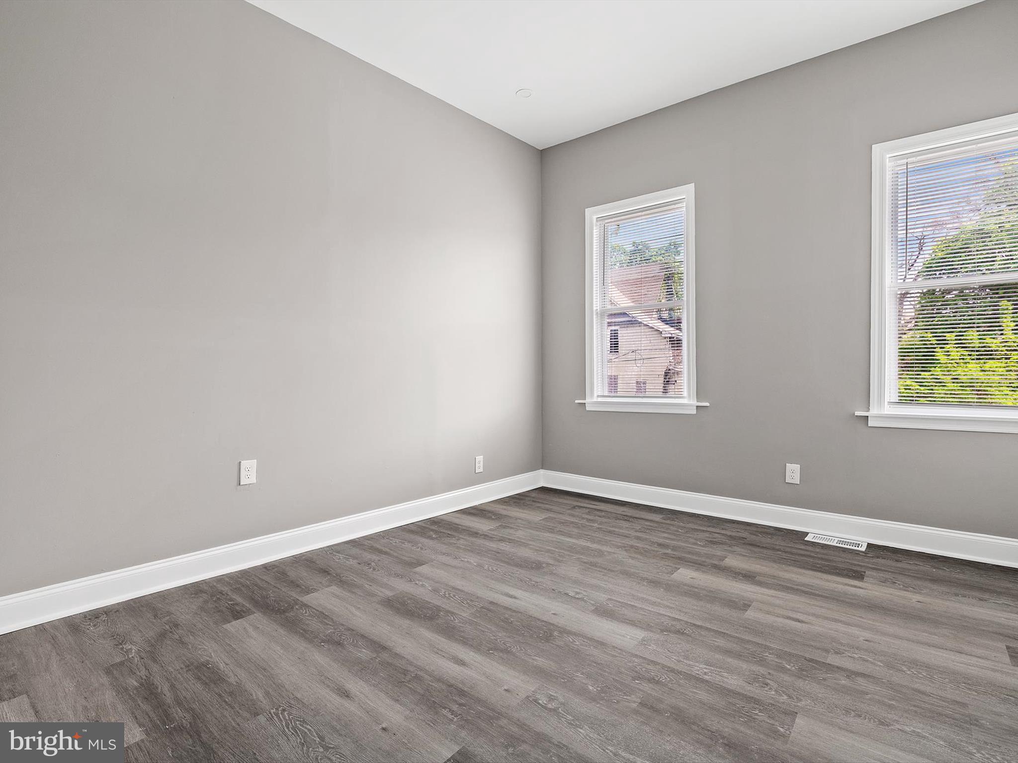 3032 Chelsea Terrace Baltimore, MD 21216 - Photo 14 of 29 a view of an empty room with wooden floor and a window