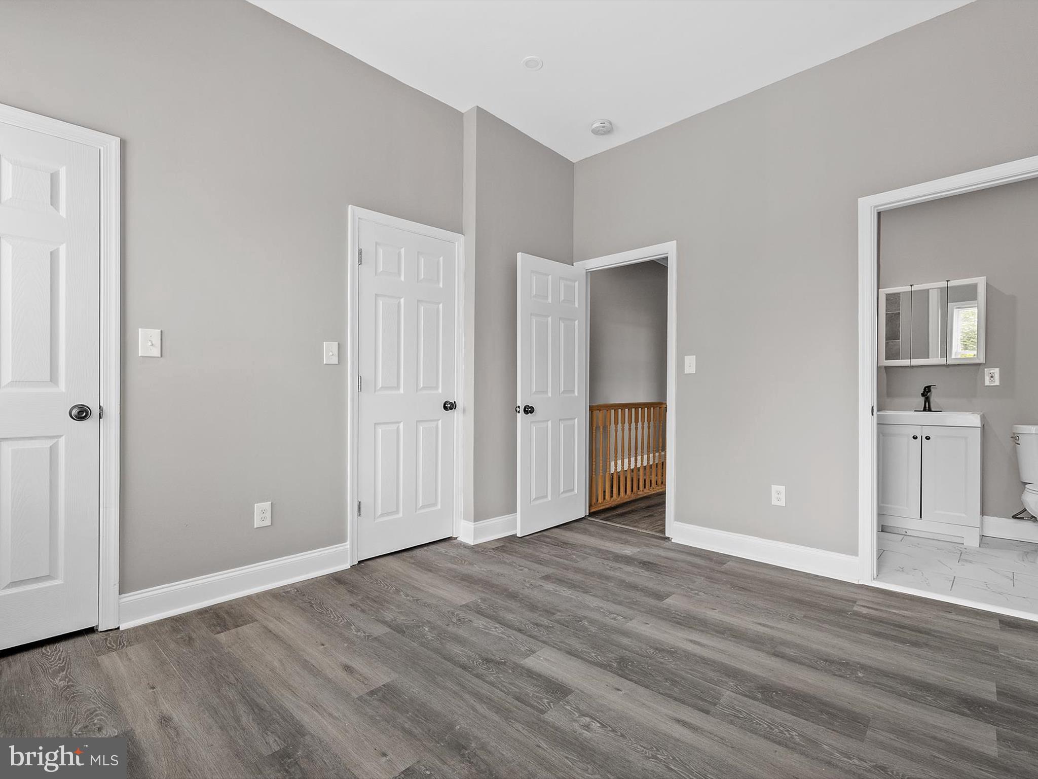 3032 Chelsea Terrace Baltimore, MD 21216 - Photo 15 of 29 an empty room with wooden floor & windows and bathroom