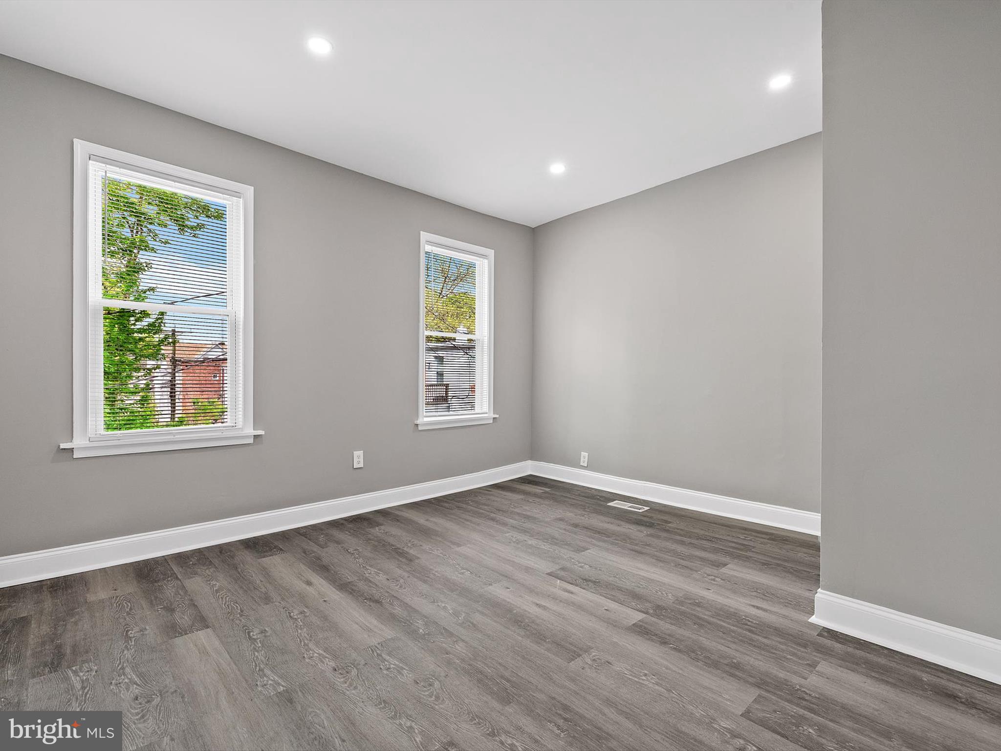 3032 Chelsea Terrace Baltimore, MD 21216 - Photo 19 of 29 an empty room with wooden floor and windows