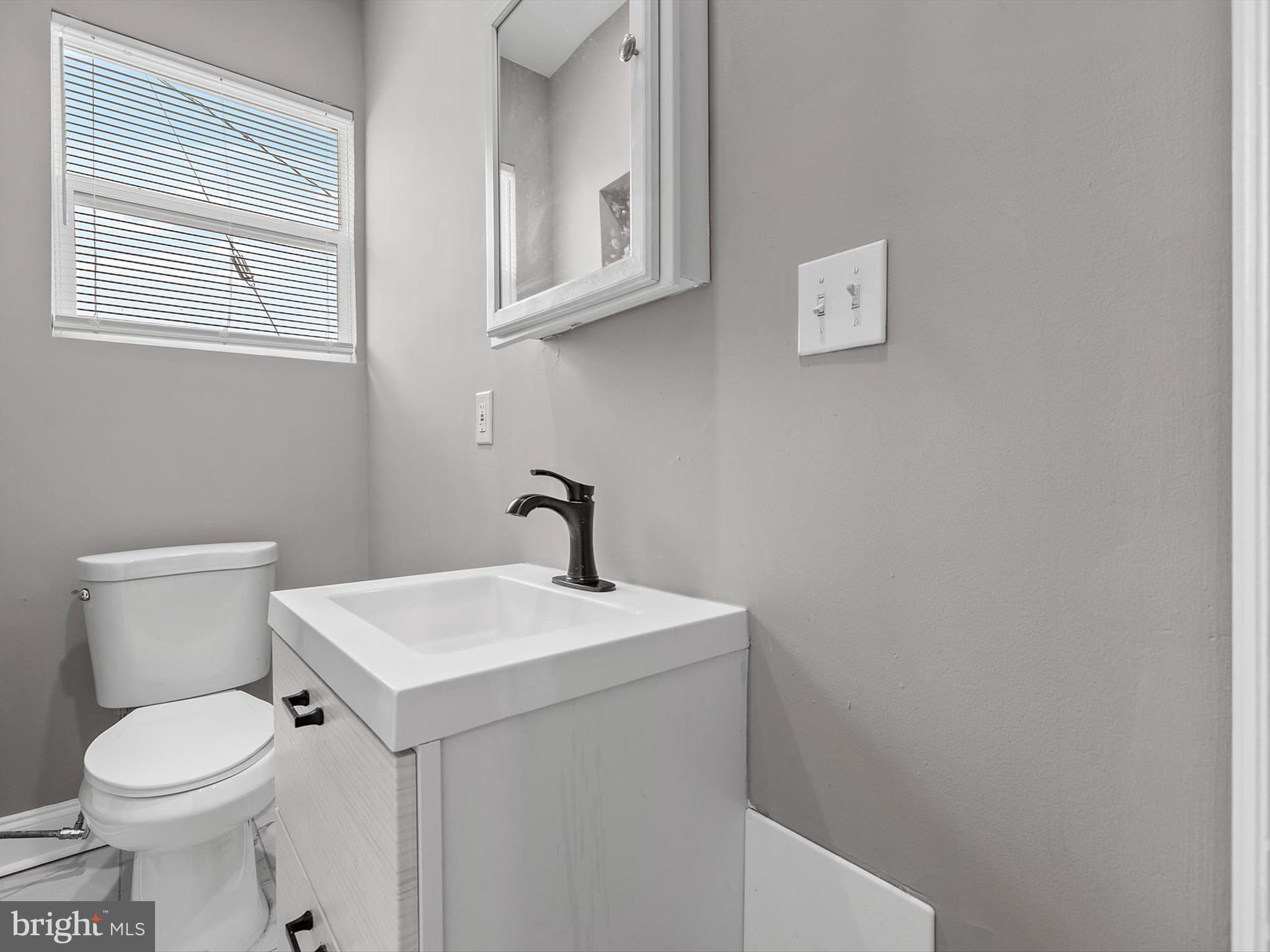 3032 Chelsea Terrace Baltimore, MD 21216 - Photo 21 of 29 a white toilet sitting next to a bathroom sink