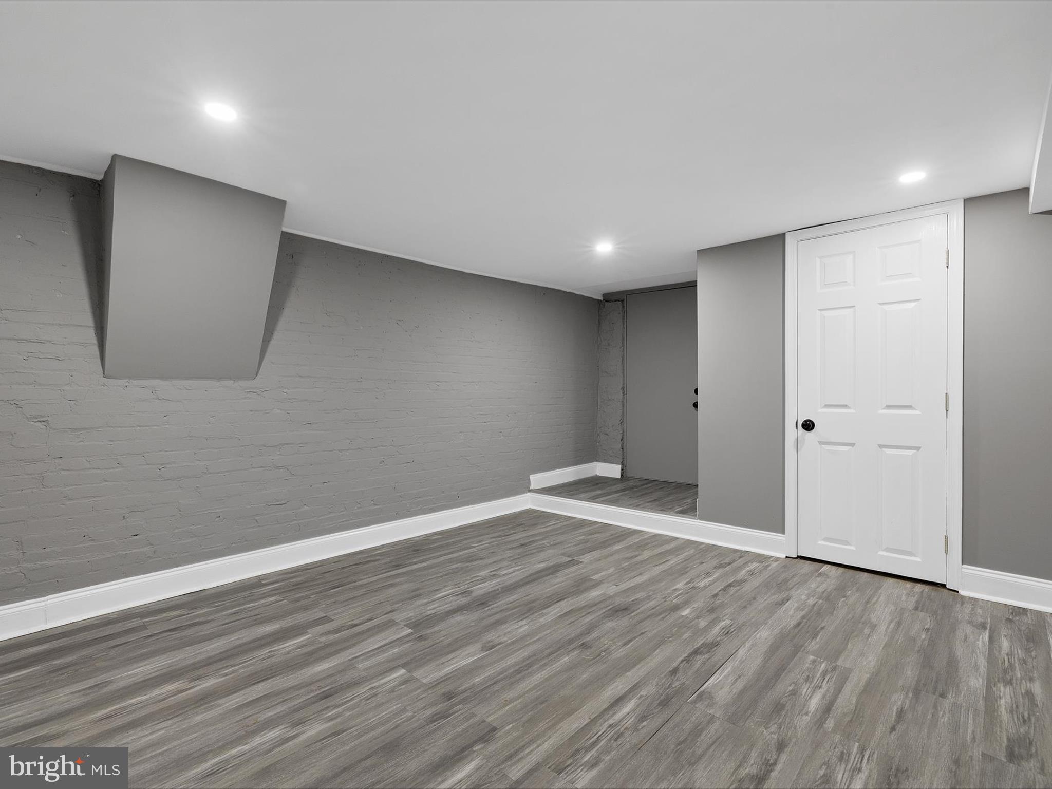 3032 Chelsea Terrace Baltimore, MD 21216 - Photo 27 of 29 a view of an empty room with wooden floor