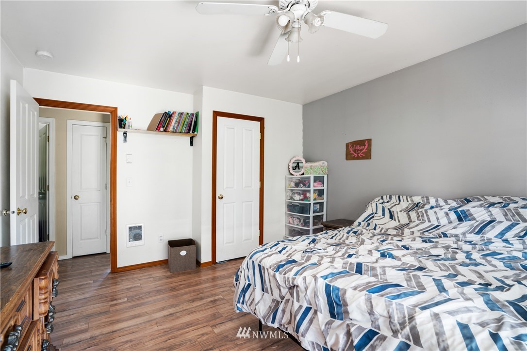 18933 Nutmeg Street Southwest Rochester, WA 98579 - Photo 11 of 18 a bedroom with a bed and a chandelier
