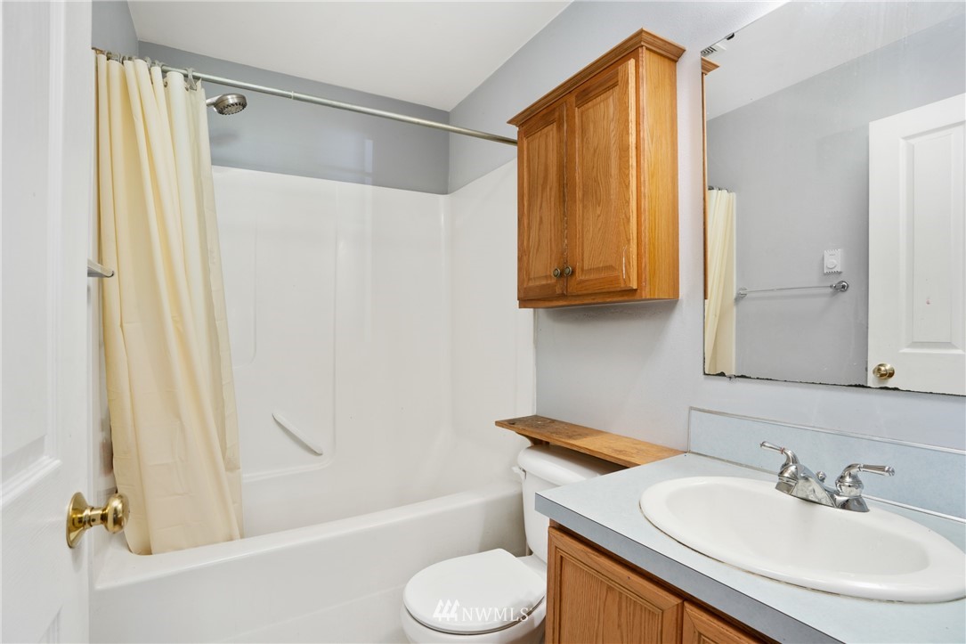 18933 Nutmeg Street Southwest Rochester, WA 98579 - Photo 9 of 18 a bathroom with a sink toilet and shower