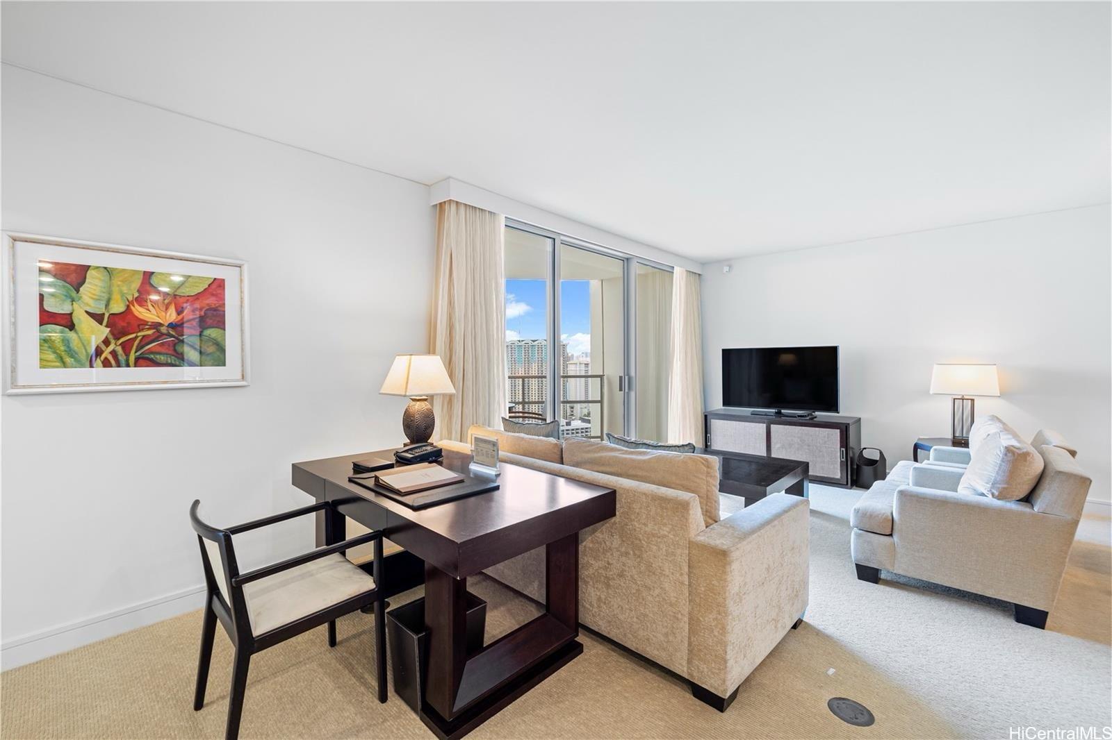 223 Saratoga Road, Unit 3203 Honolulu, HI 96815 - Photo 11 of 24 a living room with furniture and a flat screen tv