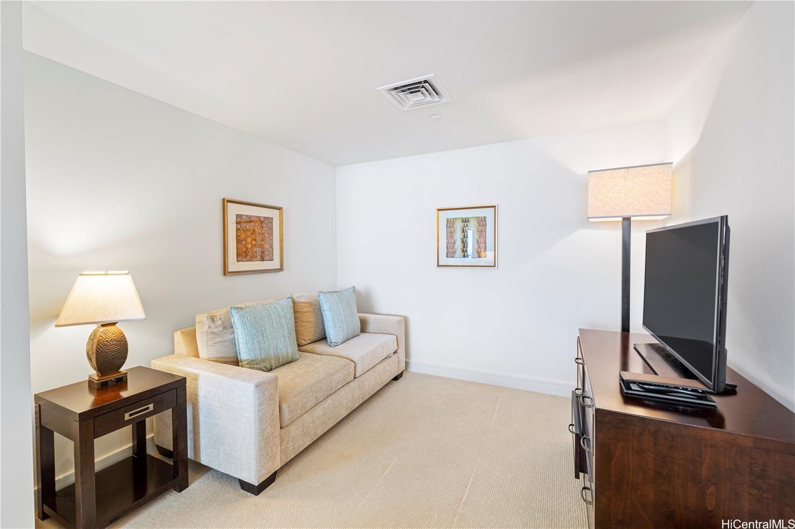 223 Saratoga Road, Unit 3203 Honolulu, HI 96815 - Photo 12 of 24 a living room with furniture and a flat screen tv