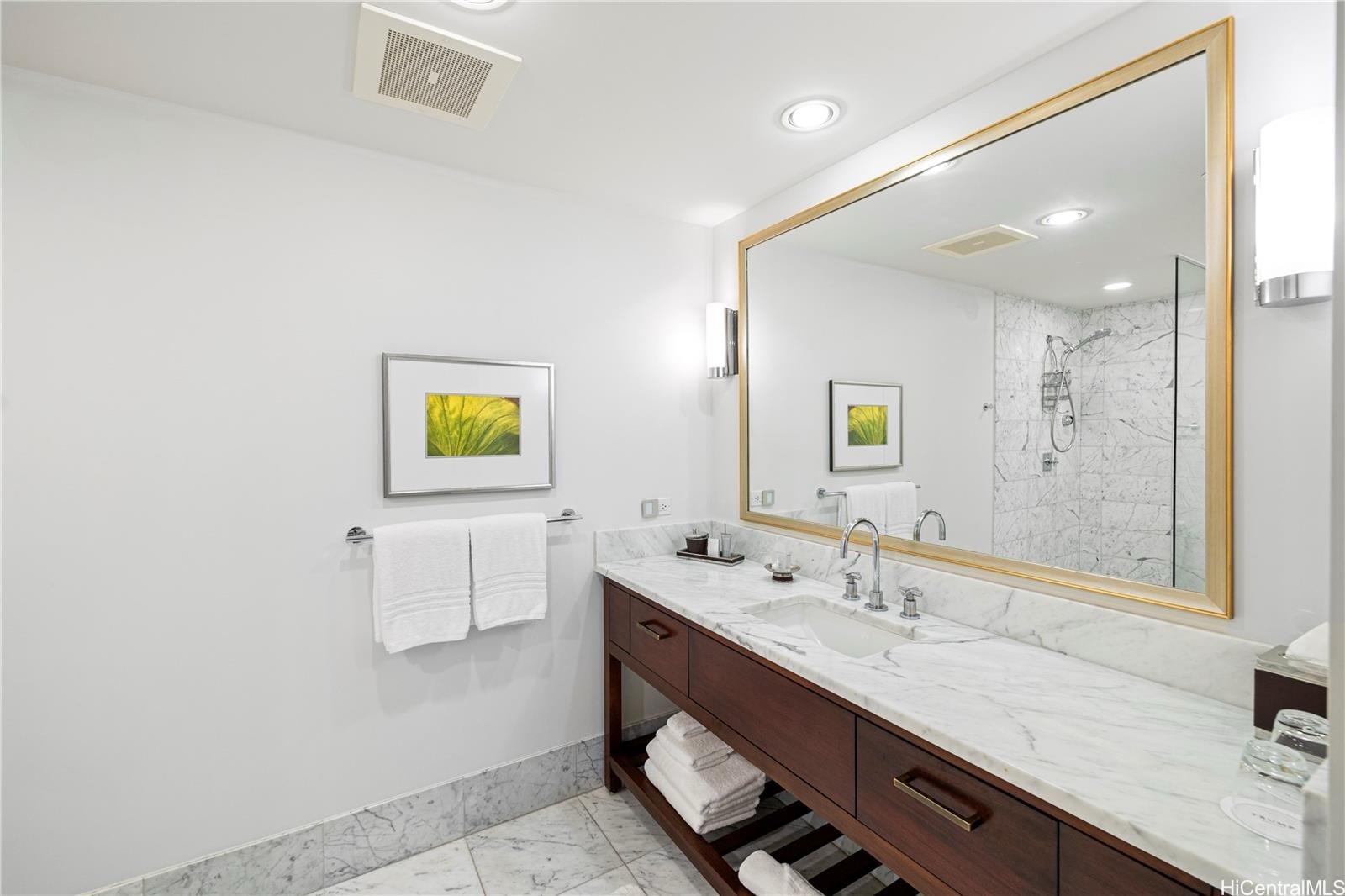 223 Saratoga Road, Unit 3203 Honolulu, HI 96815 - Photo 16 of 24 a bathroom with a sink and a mirror