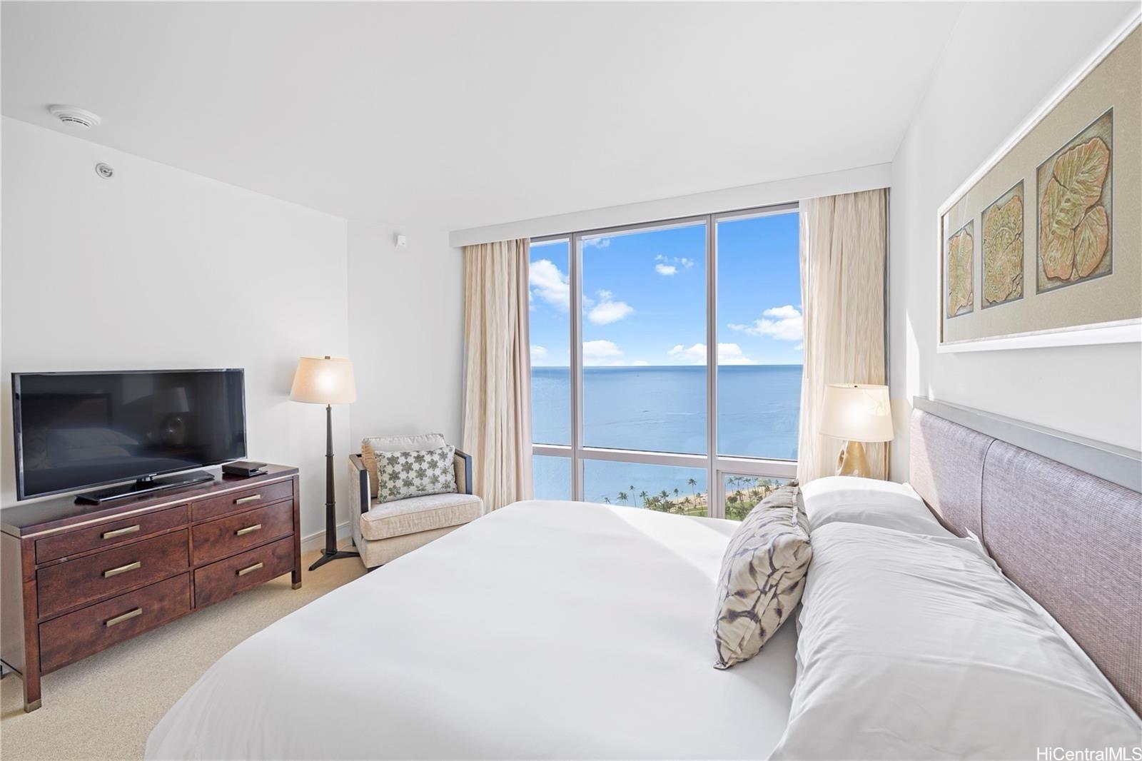 223 Saratoga Road, Unit 3203 Honolulu, HI 96815 - Photo 18 of 24 a bedroom with a bed and a flat screen tv