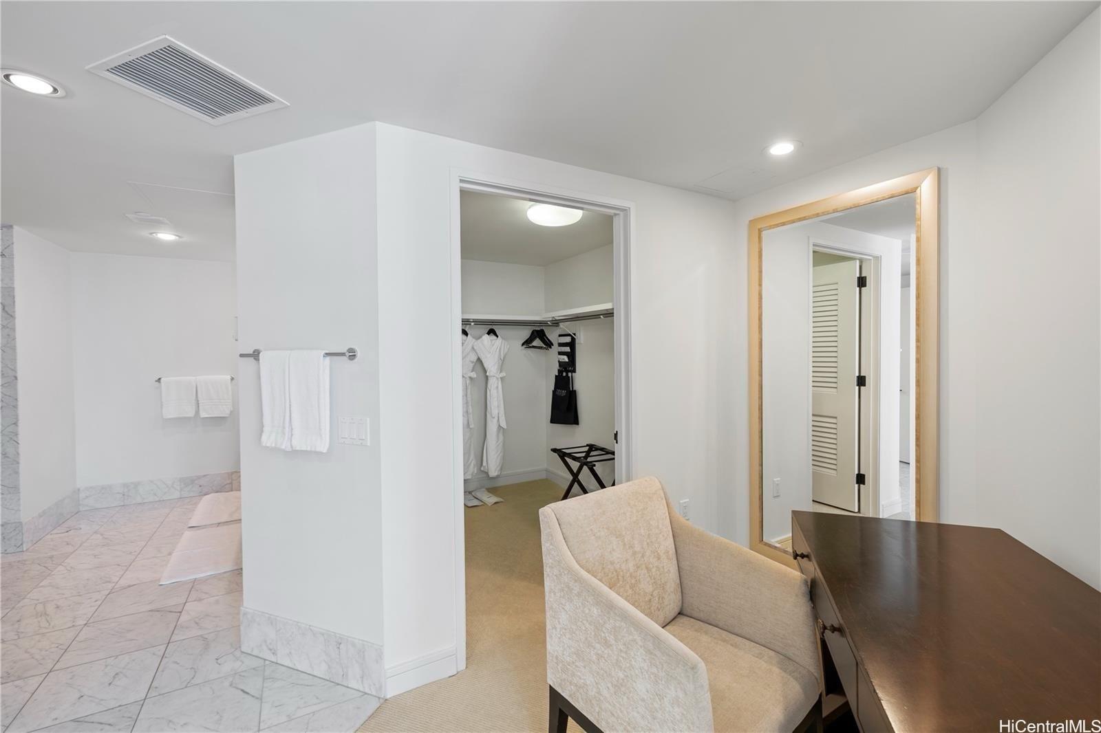 223 Saratoga Road, Unit 3203 Honolulu, HI 96815 - Photo 20 of 24 a living room with furniture and a wooden floor