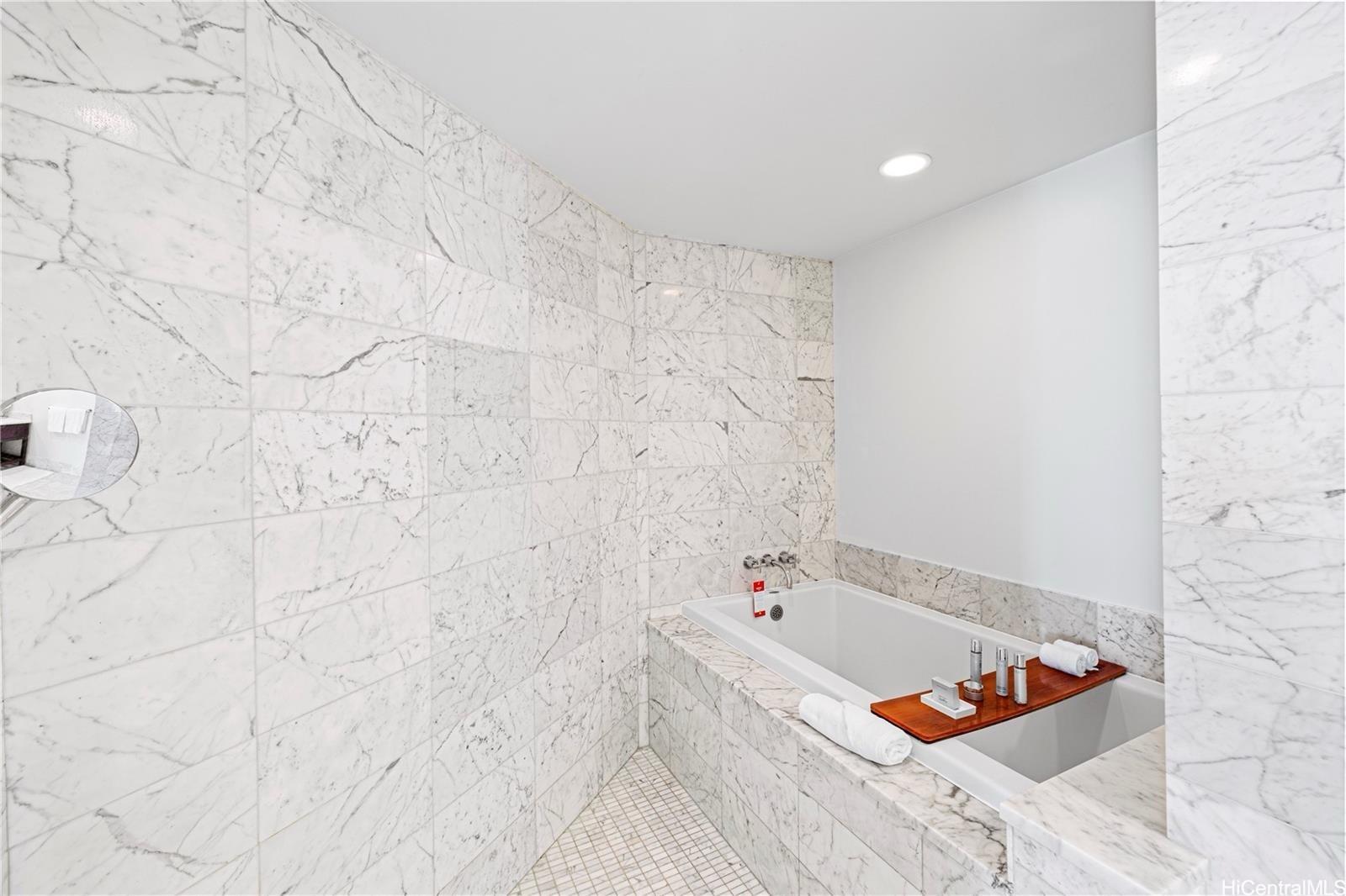 223 Saratoga Road, Unit 3203 Honolulu, HI 96815 - Photo 22 of 24 a bathroom with a tub and a shower