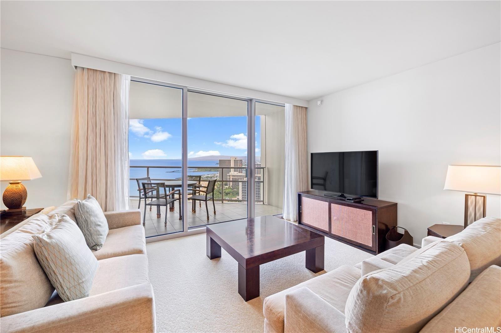 223 Saratoga Road, Unit 3203 Honolulu, HI 96815 - Photo 4 of 24 a living room with furniture and a flat screen tv