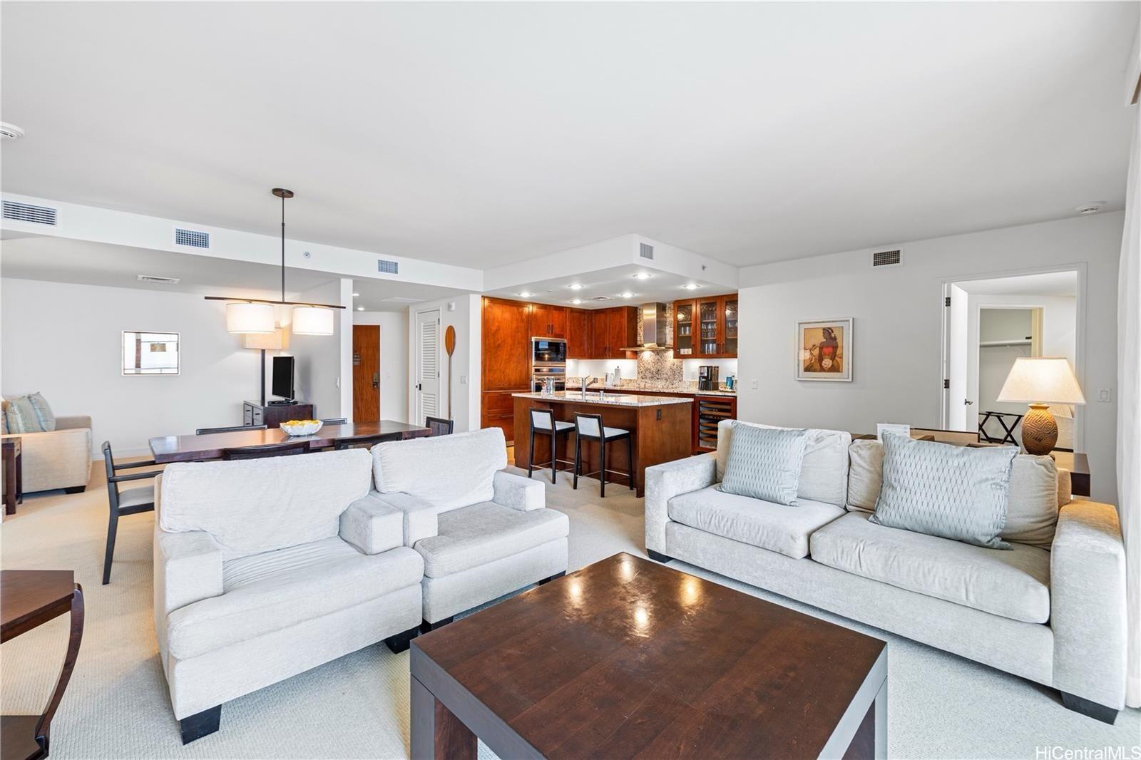 223 Saratoga Road, Unit 3203 Honolulu, HI 96815 - Photo 8 of 24 a living room with furniture and a chandelier