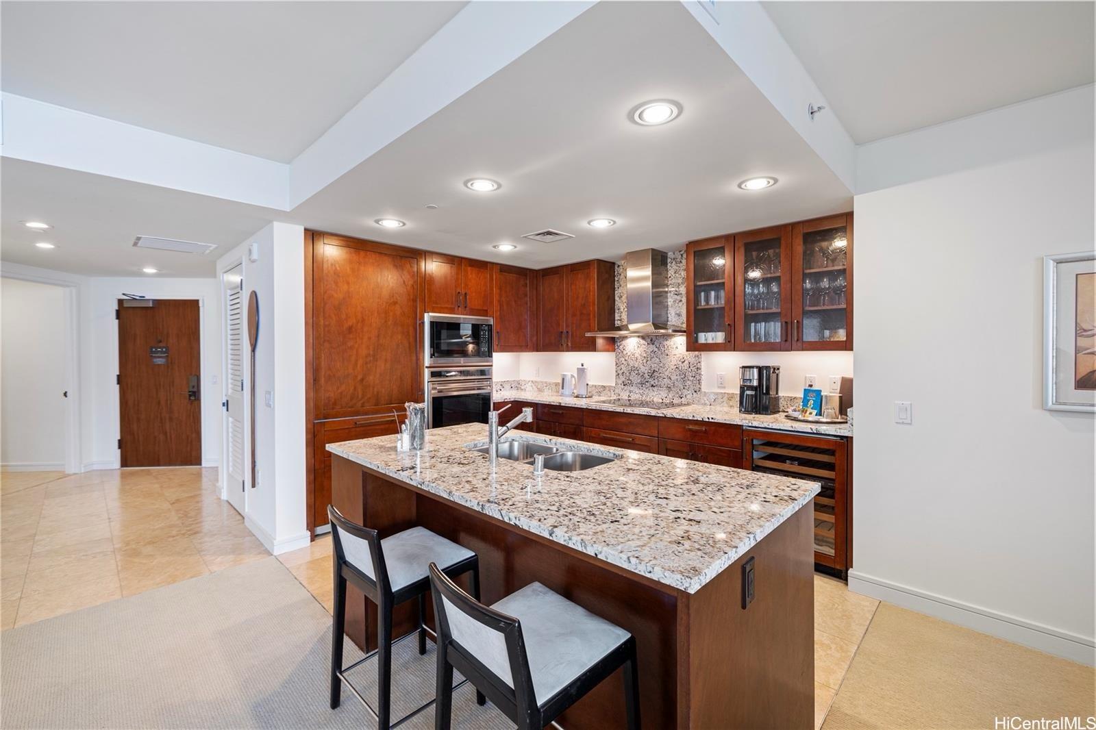 223 Saratoga Road, Unit 3203 Honolulu, HI 96815 - Photo 9 of 24 a kitchen with a table and chairs in it