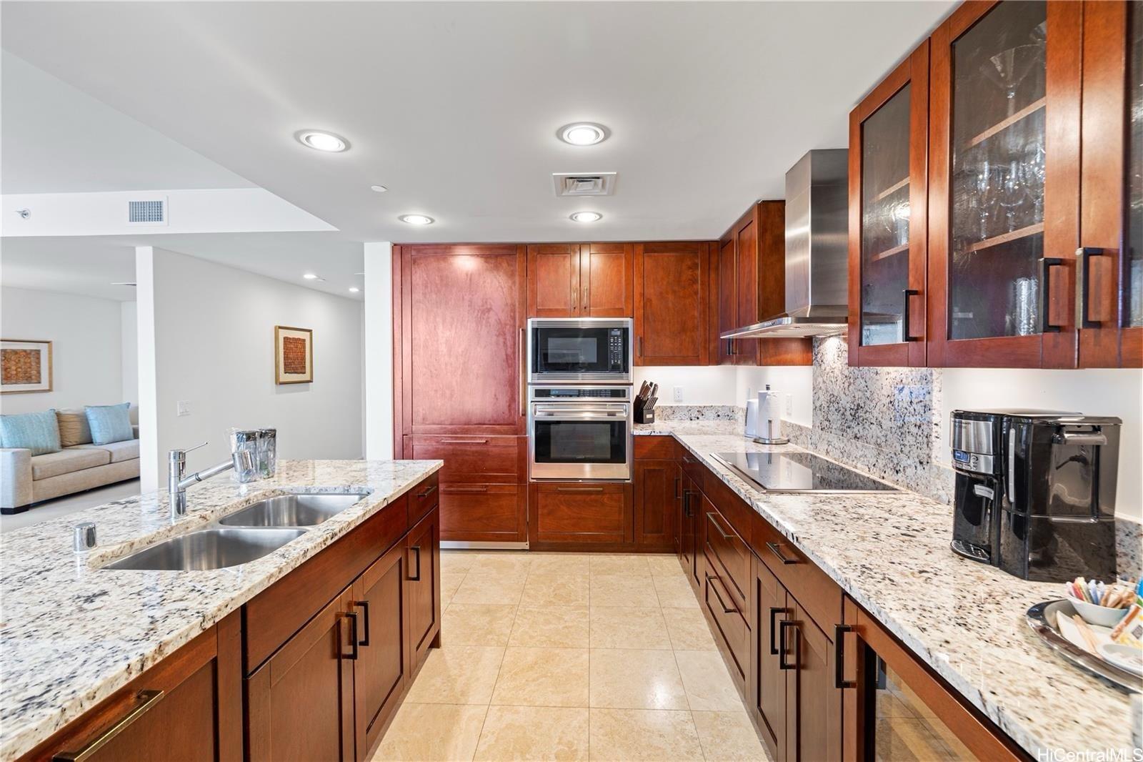 223 Saratoga Road, Unit 3203 Honolulu, HI 96815 - Photo 10 of 24 a kitchen with stainless steel appliances granite countertop a sink and stove